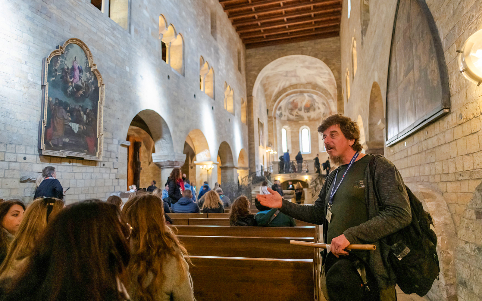 Guide explaining Basilica of St George interior to tour group.