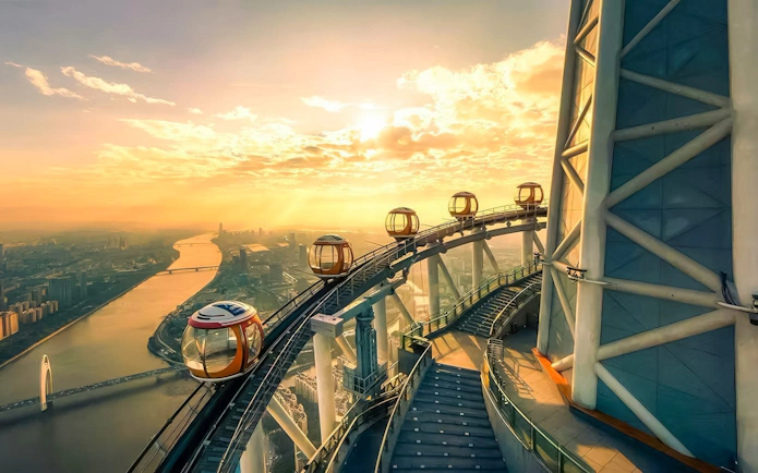 Canton Tower observation wheel at sunset overlooking Guangzhou cityscape.