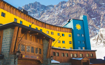 Yellow and blue Hotel Portillo in the Andes mountains, Chile.