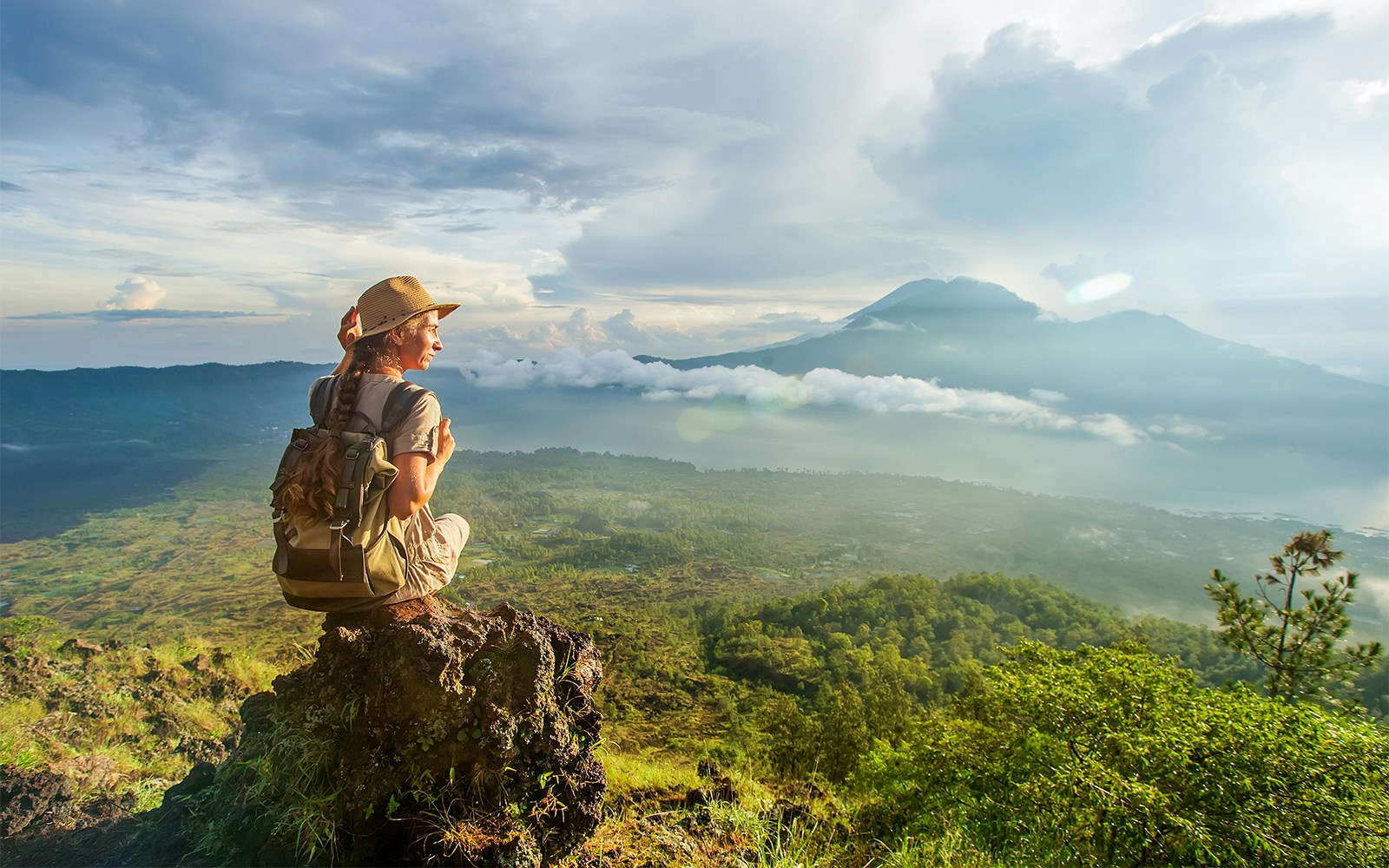 Mount Batur's volcanic landscape with lush greenery and crater lake in Bali, Indonesia.
