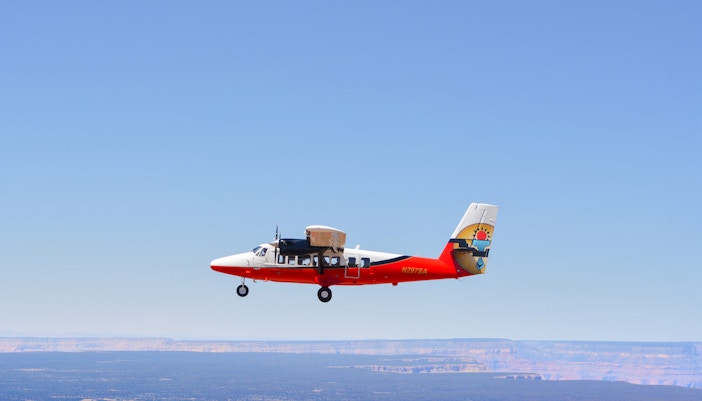 Grand Canyon South Rim aerial view with airplane flying over, Las Vegas tour.