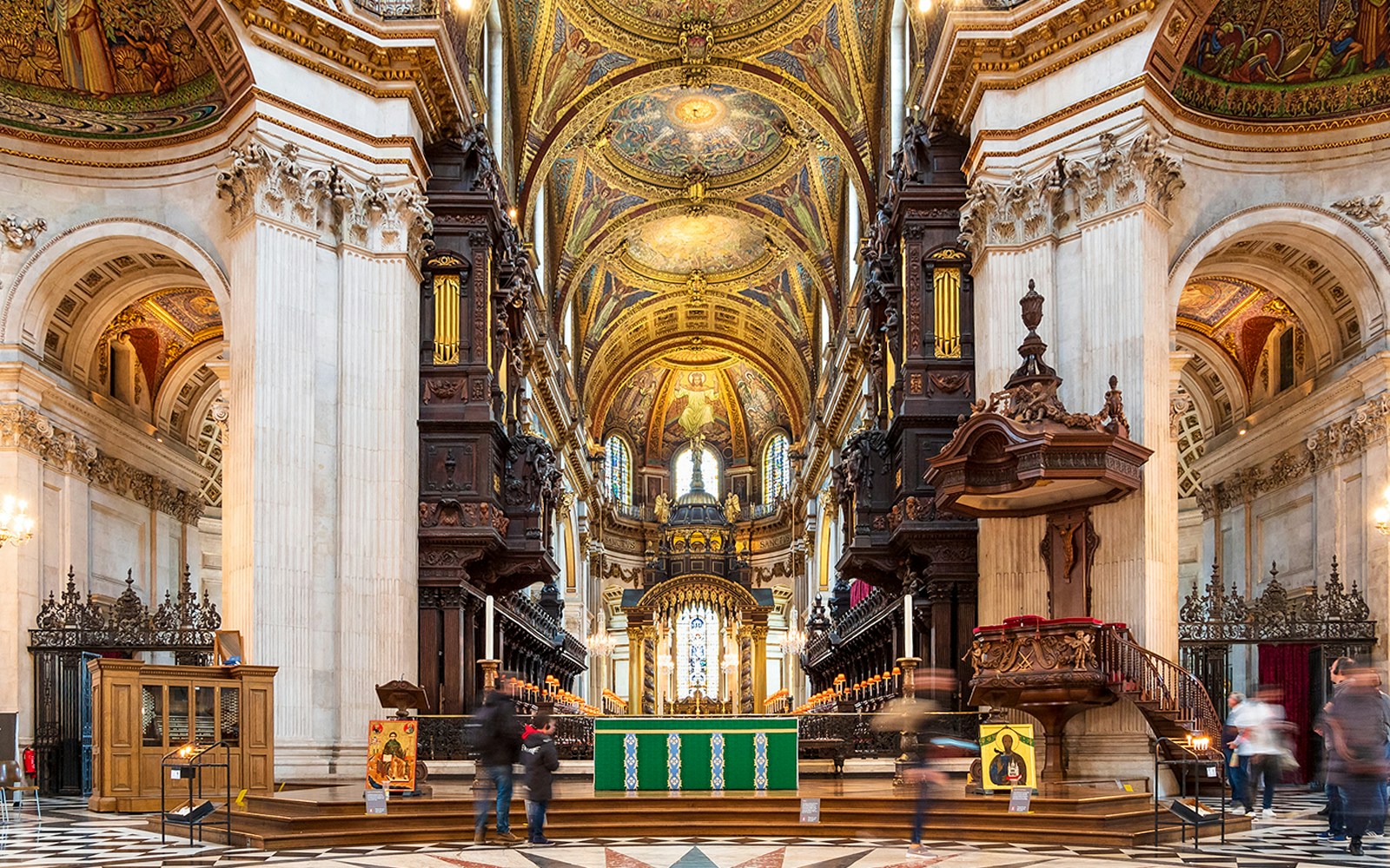 Interior of St. Paul's Cathedral, London, showcasing ornate ceiling and altar.