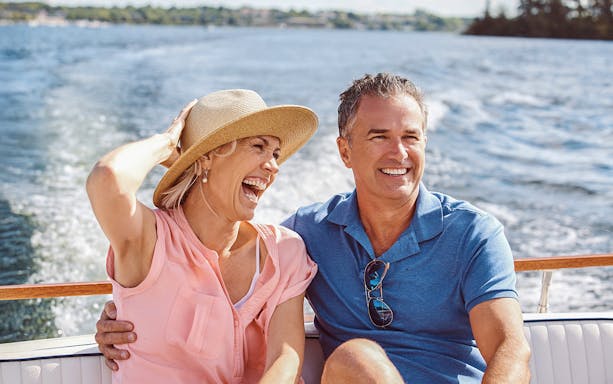 Couple enjoying a boat ride on a Sunset Cruise in South Beach, Biscayne Bay.