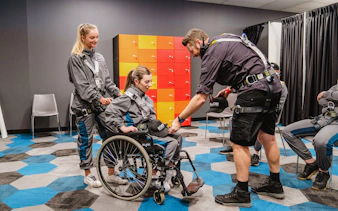 Participants preparing for Vertigo by Twilight tour with safety gear in a briefing room.
