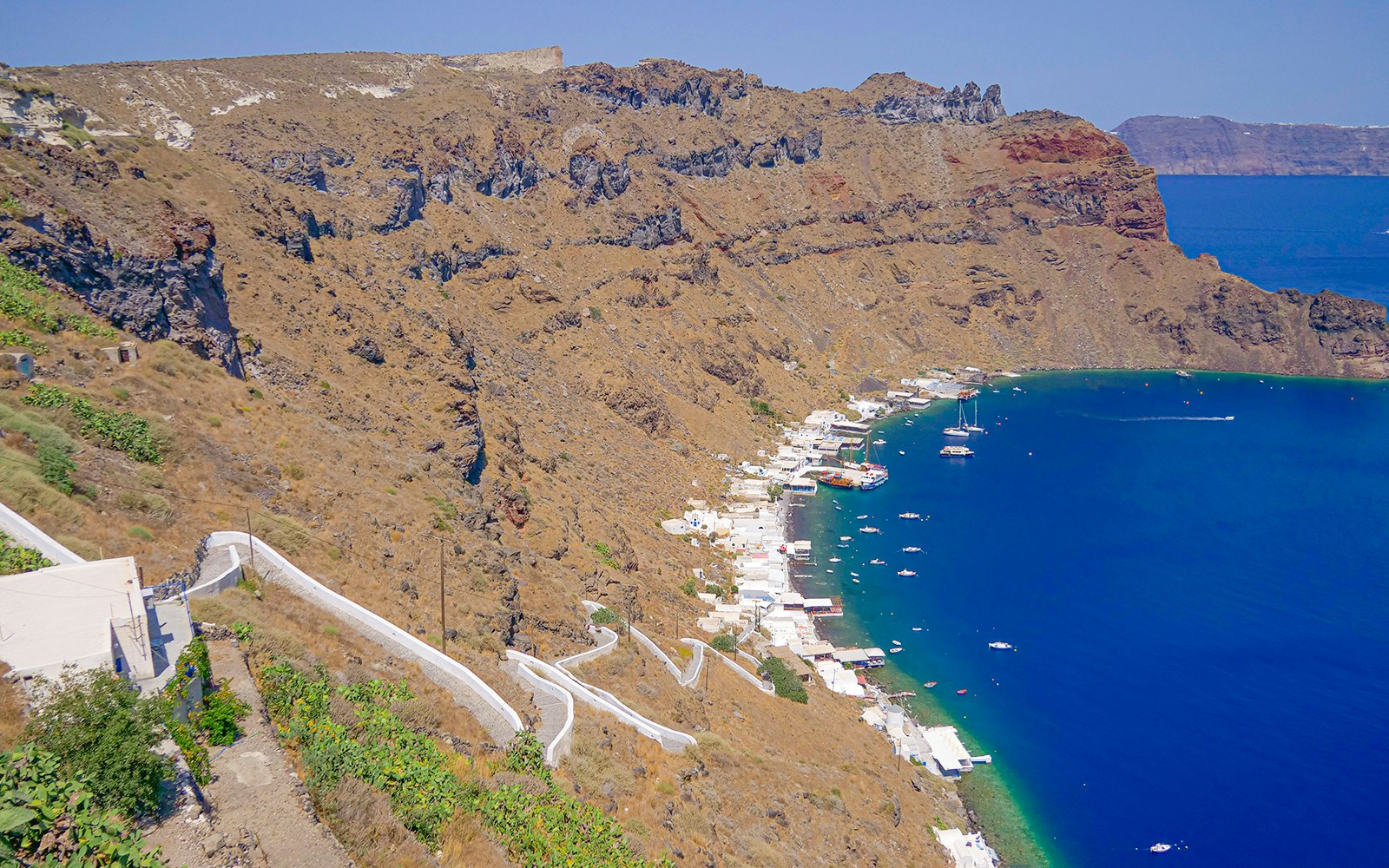 Santorini volcanic islands boat tour with view of caldera, hot springs, and Thirassia in Greece.