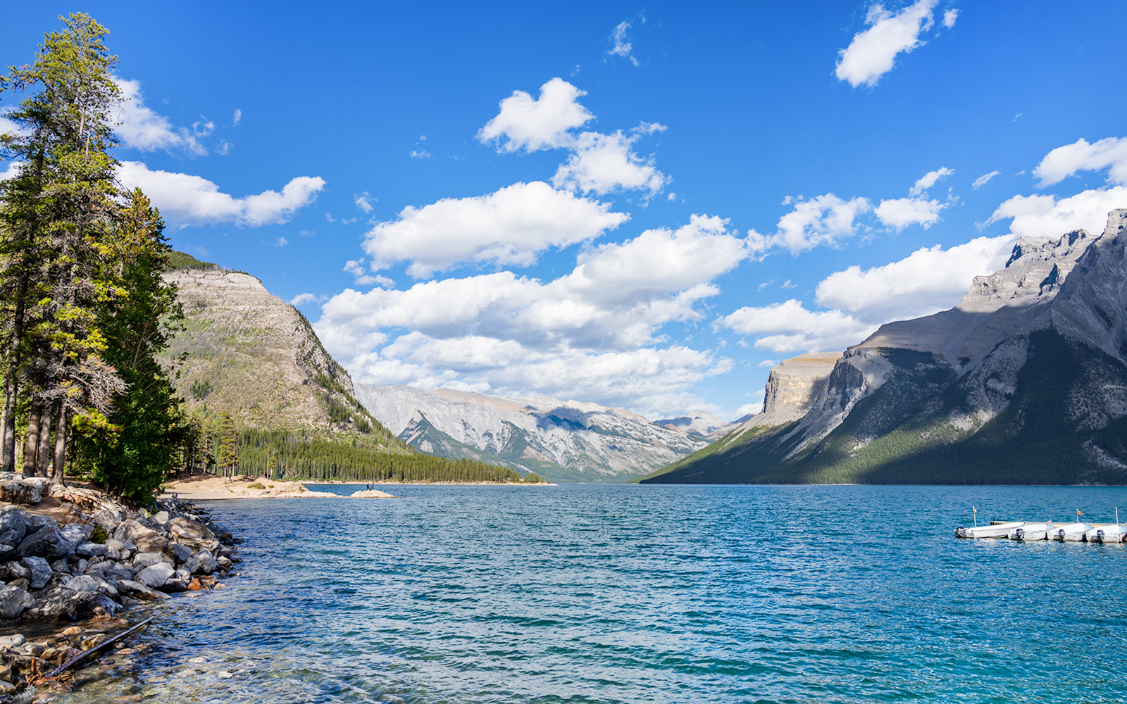 Lake Minnewanka with mountains and dock, Banff, Canada.