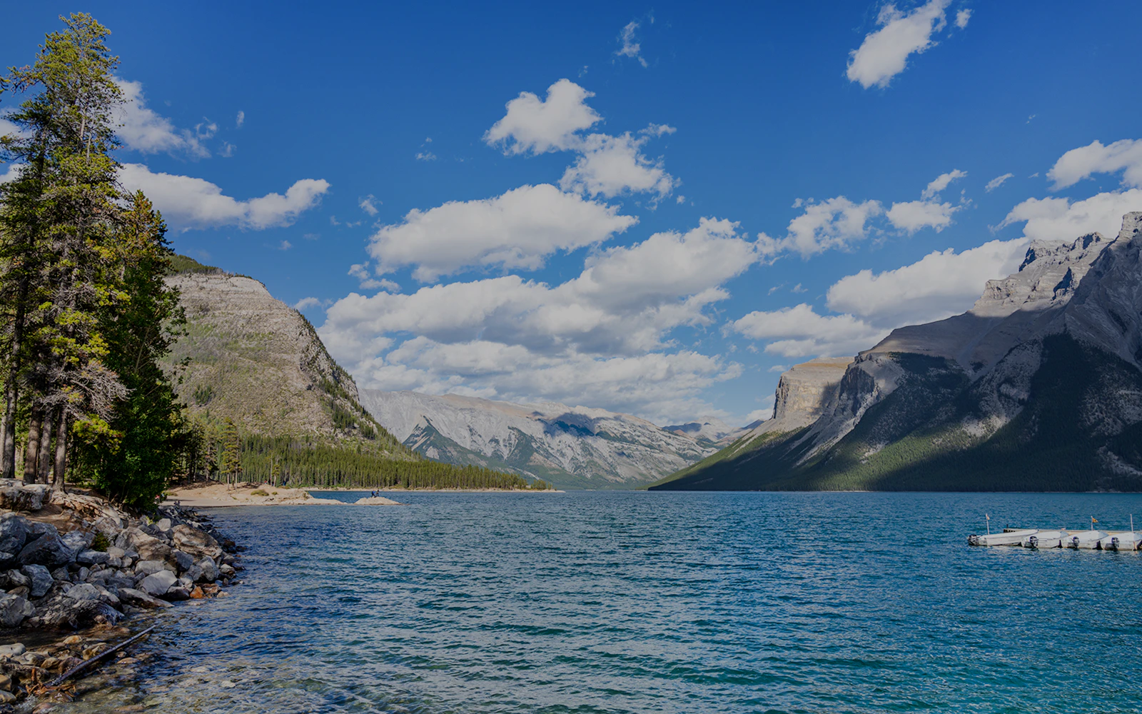 Lake Minnewanka with mountains and dock, Banff, Canada.