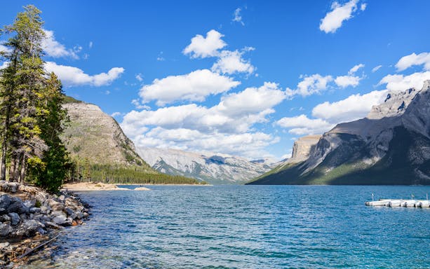 Lake Minnewanka with mountains and dock, Banff, Canada.