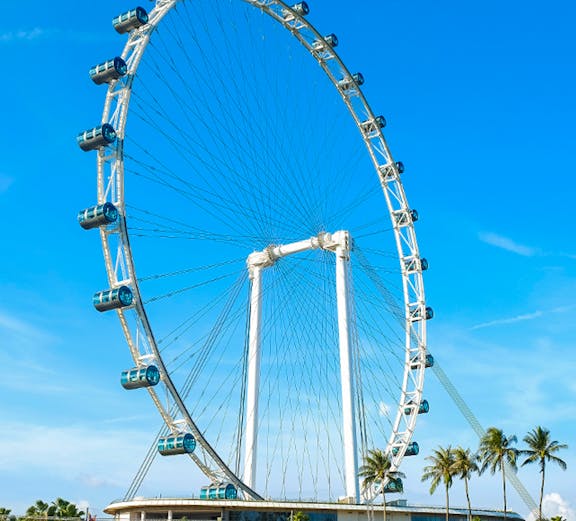 Ferris wheel at Singapore Flyer against blue sky.