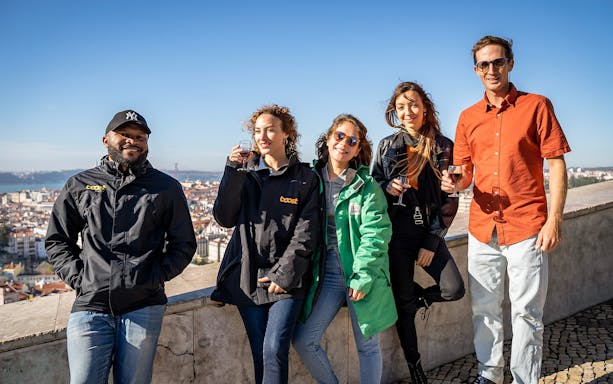 Group enjoying a view of Lisbon on a private electric tuk tuk tour.