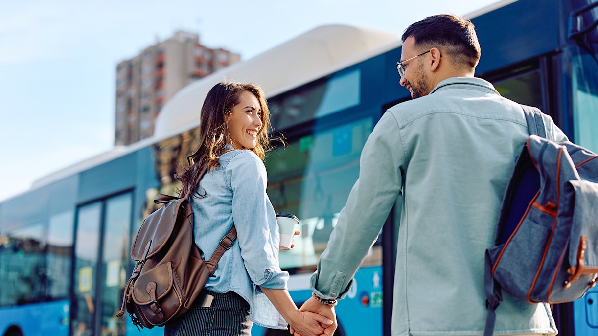 Couple getting on the bus