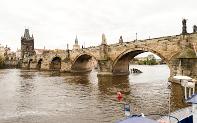 Charles Bridge viewed from a sightseeing cruise on the Vltava River in Prague.