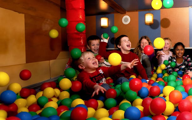 Children playing in a colorful ball pit on the Pancake Cruise in Amsterdam.