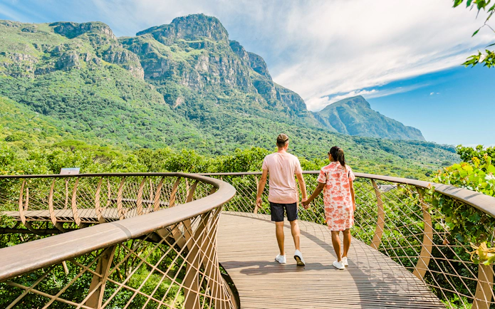 Couple walking on treetop walkway at Kirstenbosch Botanical Gardens, Cape Town.