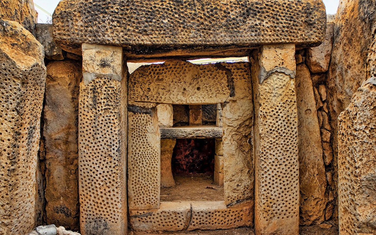 Mnajdra megalithic temple entrance with ancient stone structures, Malta.