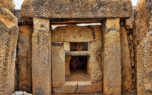 Mnajdra megalithic temple entrance with ancient stone structures, Malta.
