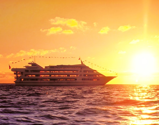 Star of Honolulu cruise ship sailing at sunset in Hawaii.