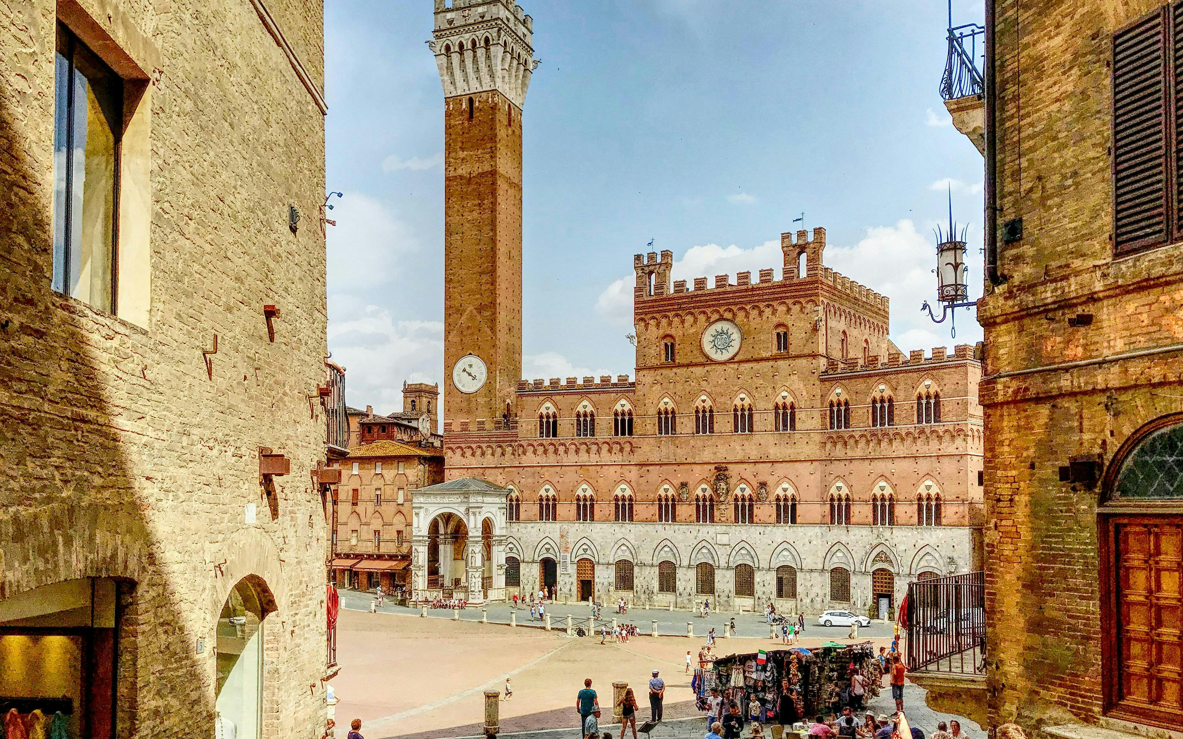 Torre del Mangia and Palazzo Pubblico in Siena's Piazza del Campo, Italy.