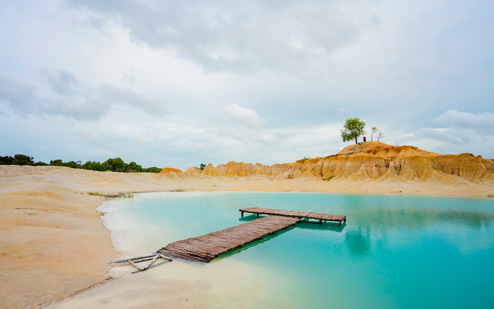 Wooden pier over turquoise water at Blue Lake, Bintan Mini Desert.