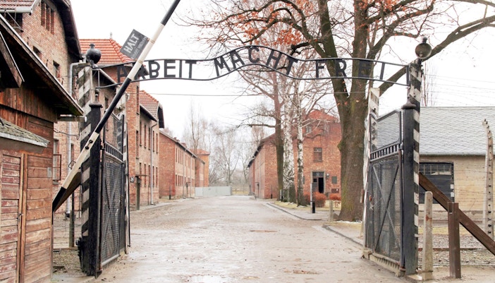 Auschwitz tour group from Wroclaw exploring historical barracks and memorial site.
