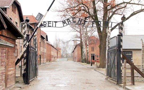 Entrance gate of Auschwitz concentration camp with "Arbeit Macht Frei" sign, tour from Wroclaw.