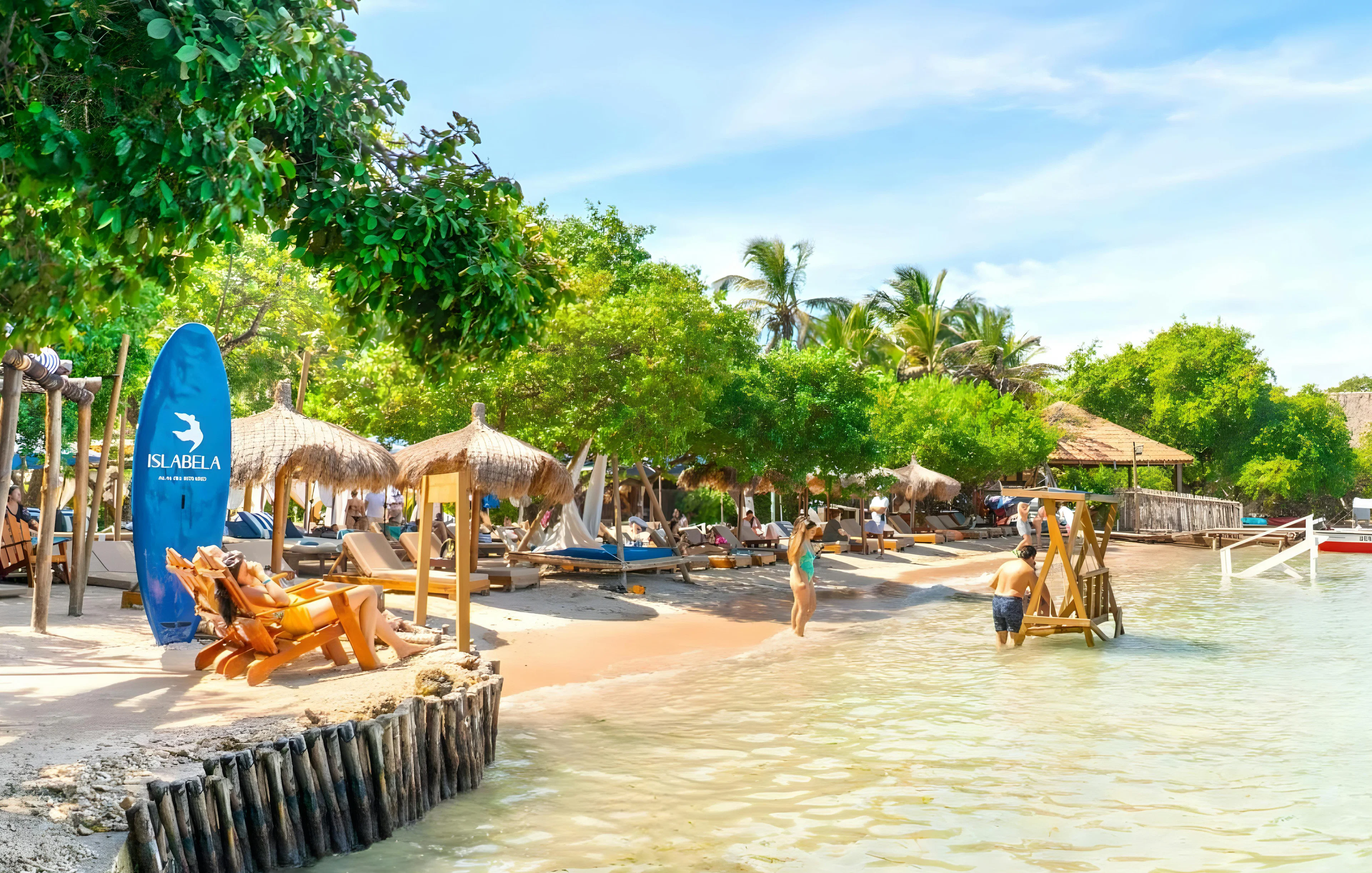 Beachfront with lounge chairs and palm trees on a beach island in the Rosario Islands near Cartagena, Colombia.
