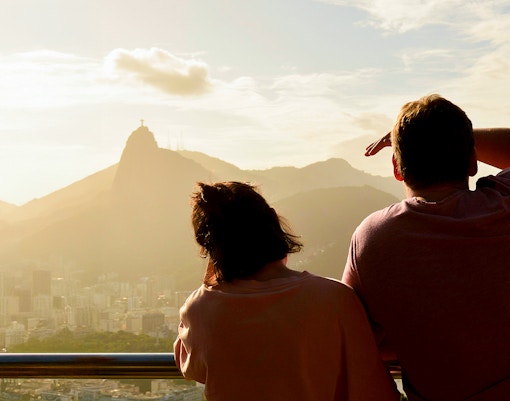 Couple admiring Christ the Redeemer statue from Sugarloaf Mountain, Rio de Janeiro.