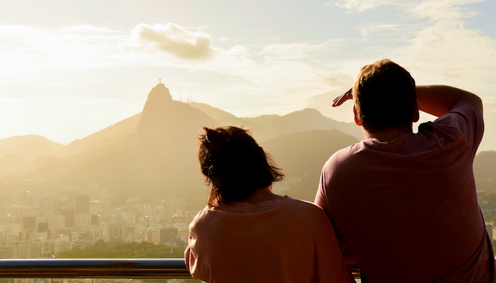 Couple viewing Christ the Redeemer from Sugarloaf Mountain, Rio de Janeiro.