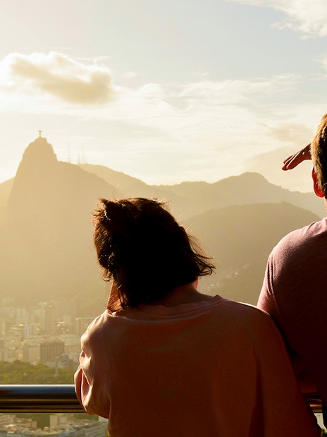 Couple viewing Christ the Redeemer from Sugarloaf Mountain, Rio de Janeiro.