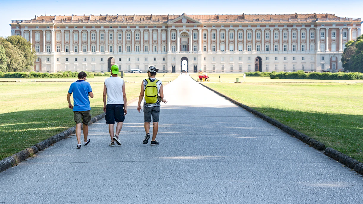 Visitors walking towards the Royal Palace of Caserta in Italy.