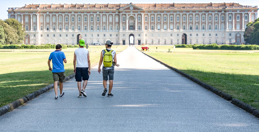 Visitors walking towards the Royal Palace of Caserta in Italy.