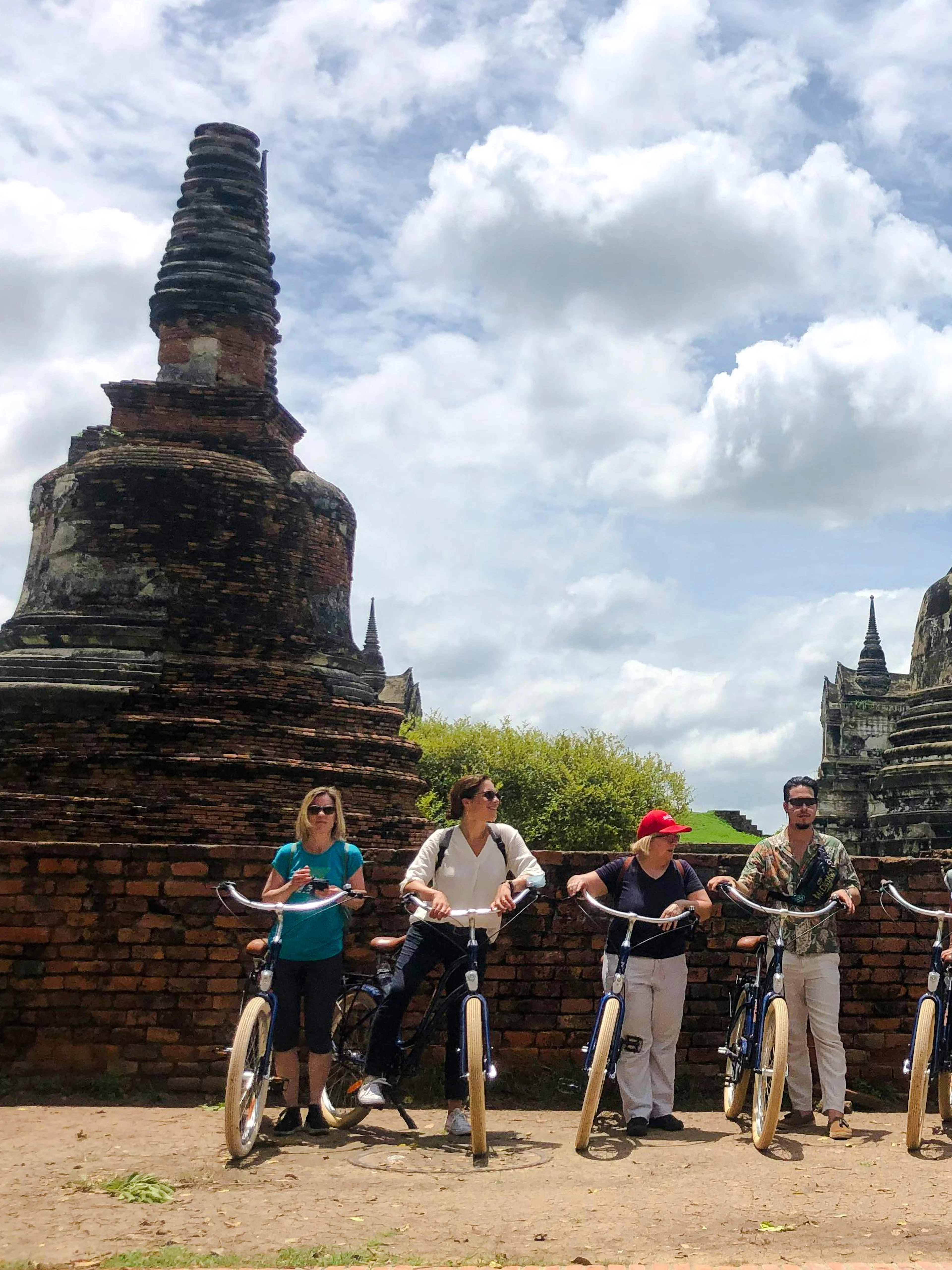 Cyclists exploring ancient ruins in Ayutthaya, Thailand.