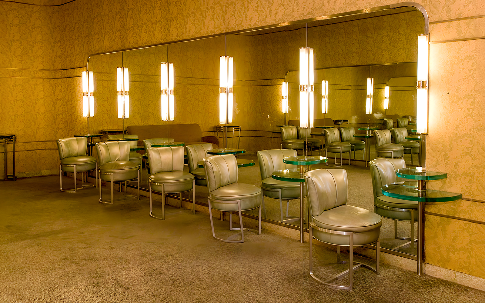 Art Deco lounge area at Radio City Music Hall with mirrored walls and vintage seating.