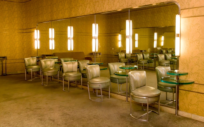 Art Deco lounge area at Radio City Music Hall with mirrored walls and vintage seating.