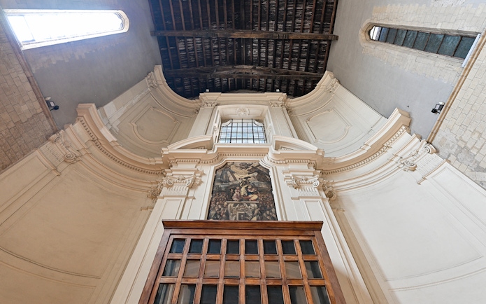 San Lorenzo Maggiore interior with ornate architecture and fresco in Naples, Italy.