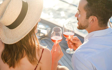 Couple enjoying wine on Calanques sailing cruise.