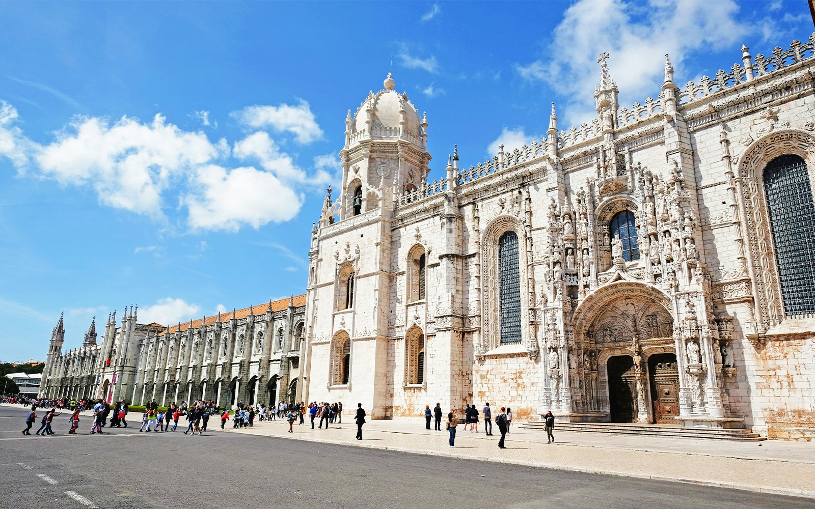 Visitors entering Jeronimos Monastery in Lisbon, Portugal.