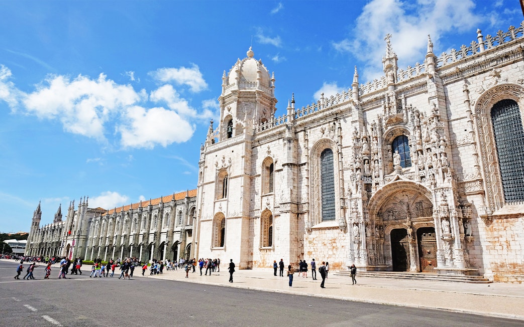 Visitors entering Jeronimos Monastery in Lisbon, Portugal.