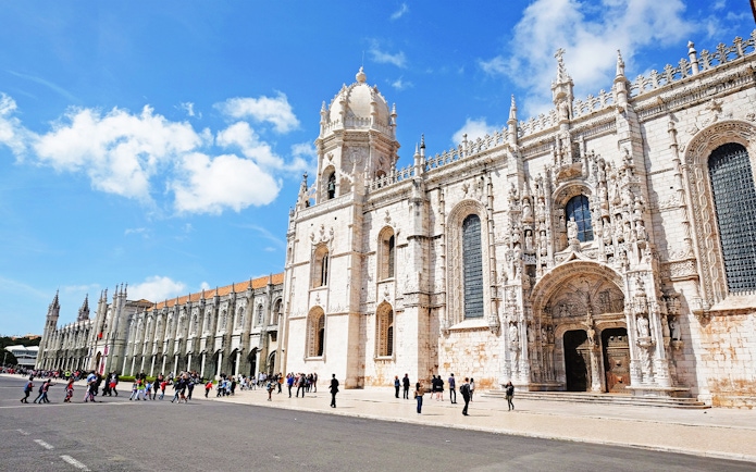 Visitors entering Jeronimos Monastery in Lisbon, Portugal.