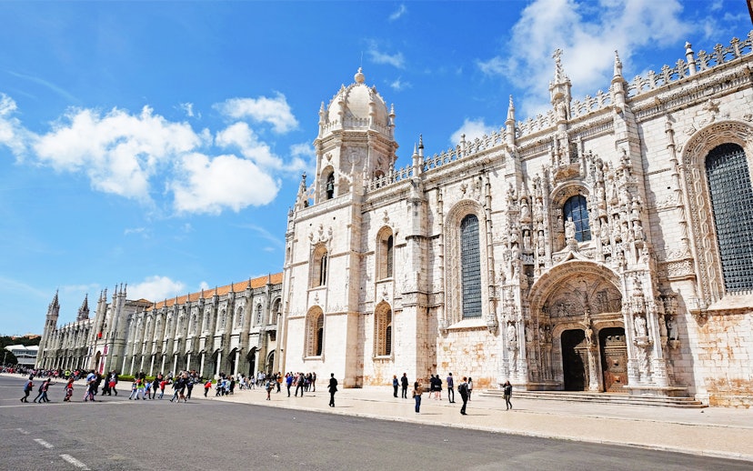Visitors entering Jeronimos Monastery in Lisbon, Portugal.