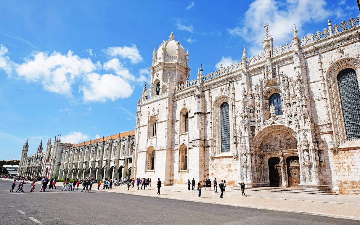 Visitors entering Jeronimos Monastery in Lisbon, Portugal.