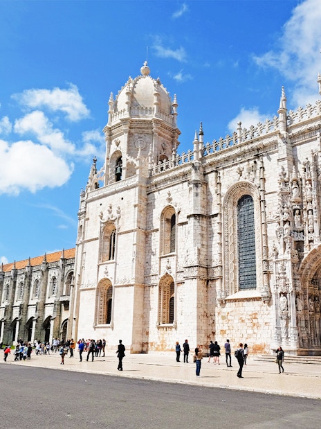 Visitors entering Jeronimos Monastery in Lisbon, Portugal.