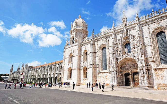Visitors entering Jeronimos Monastery in Lisbon, Portugal.