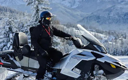 Snowmobile rider in snowy Zakopane landscape during Krakow tour.
