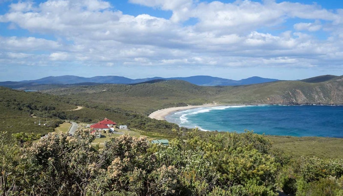 Bruny Island coastline with rocky cliffs and ocean waves at Cloudy Bay, Tasmania.