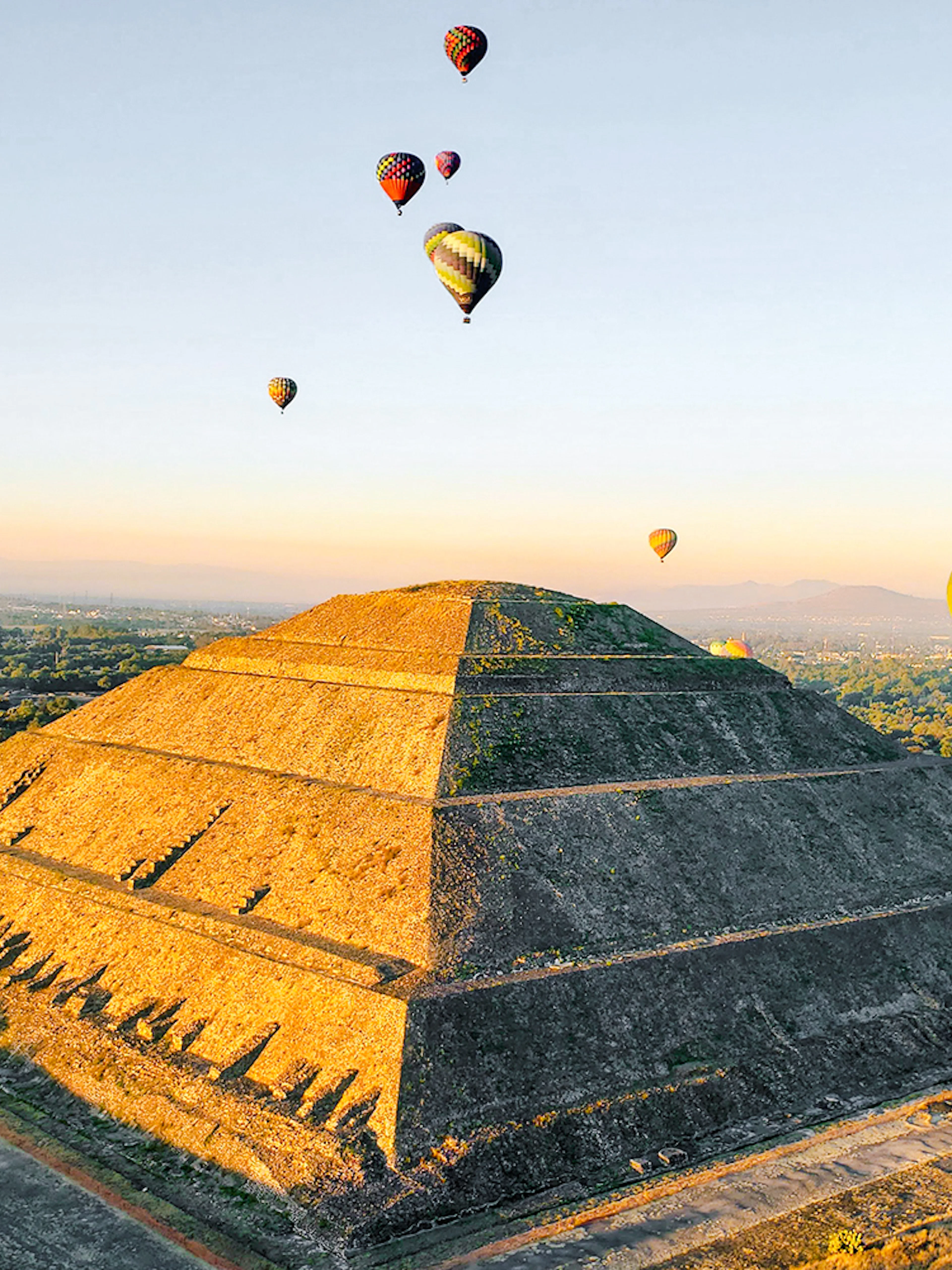 Hot air balloons over Pyramid of the Sun, Teotihuacan, Mexico.