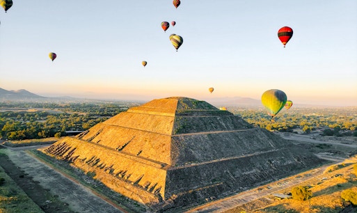 Hot air balloons over Pyramid of the Sun, Teotihuacan, Mexico.