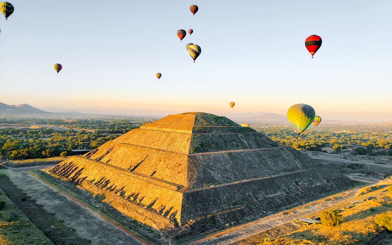 Hot air balloons over Pyramid of the Sun, Teotihuacan, Mexico.