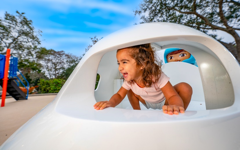 Child playing in a spaceship-themed playground at LEGOLAND California Resort.