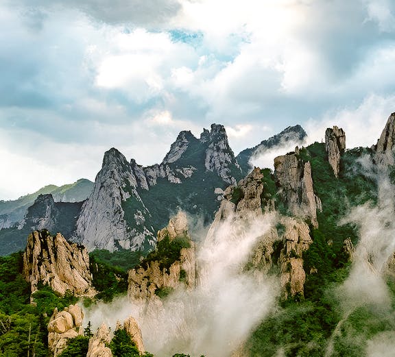 Seorak Mountain peaks with mist and lush greenery in South Korea.